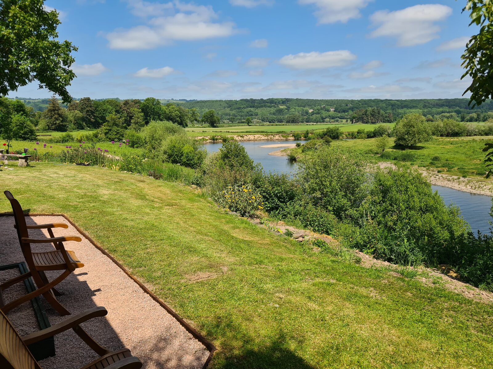 The view from the wagon's garden across the meadow to the river